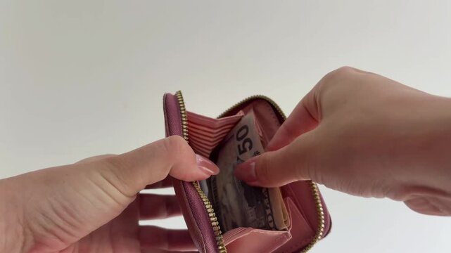 Woman taking us dollar banknotes from her pink leather wallet, illustrating personal finance management, consumer spending, and payment for goods and services on a white background