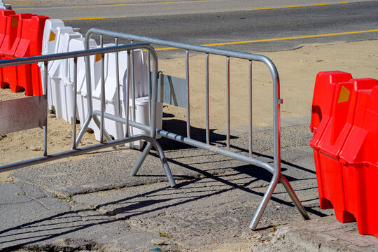 Crowd control metal barricades set up on asphalt road for security and safety perimeter