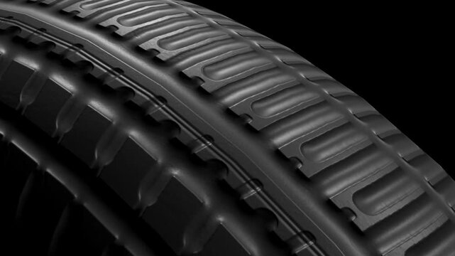 Closeup 3d animation loop of car tire on black background