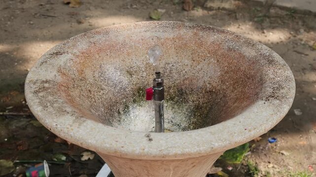 Public drinking water fountain pouring in park