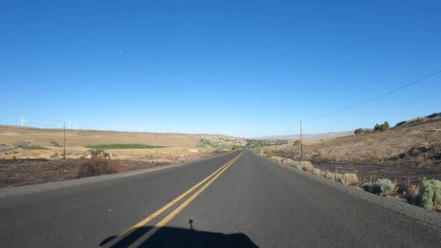 4K action camera footage from a car hood driving countryside roads toward Highway 19 near Arlington, Oregon, USA, through open fields, farms and rural areas of north eastern Oregon