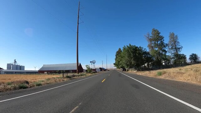 4K action camera footage driving on a rural road near Arlington, Oregon, USA, passing a huge solar panel field surrounded by open farmland in north eastern Oregon