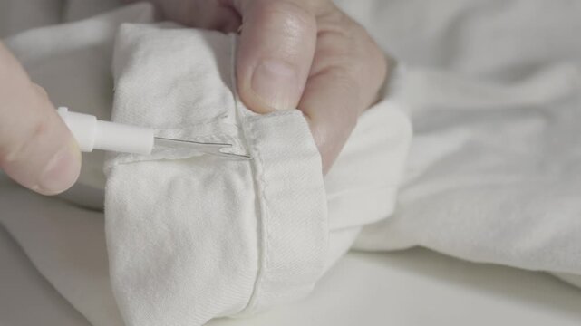 Seamstress at work with seam ripper