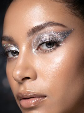 AI generated close up portrait of a woman with intense silver metallic eyeshadow and glowing skin