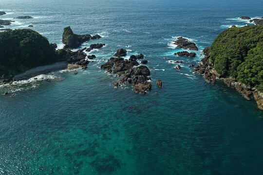 Aerial drone photo of rocky coastline and clear shallow sea in Kushimoto, Wakayama, Japan
