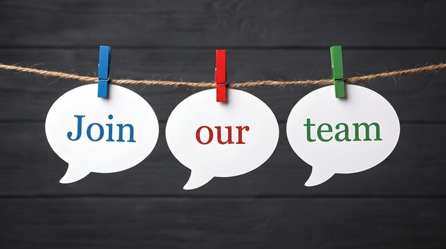 Join our team a recruitment message shown on white speech bubbles suspended from a string on a dark wood backdrop