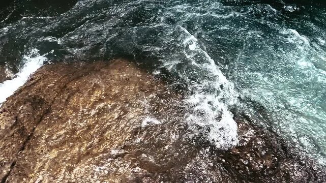 Close View of Clear Water Flowing Over Smooth Rocks in Ecuador Rainforest River, Freshwater Texture, Rapids and Tropical Nature Background