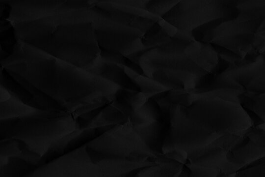 Number 50 silhouette formed by folds and creases in dark black paper texture fifty digit
