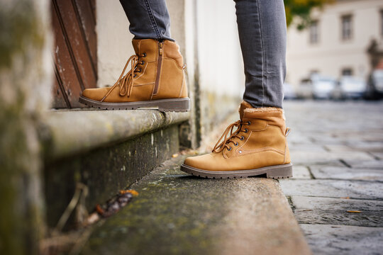 Leather ankle boots on stairs in city. Autumn fashion street style