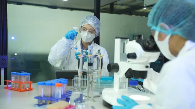 Researcher testing water purity through a microscope, monitoring soil moisture and crop health in a modern laboratory, advancing agricultural science and sustainability.