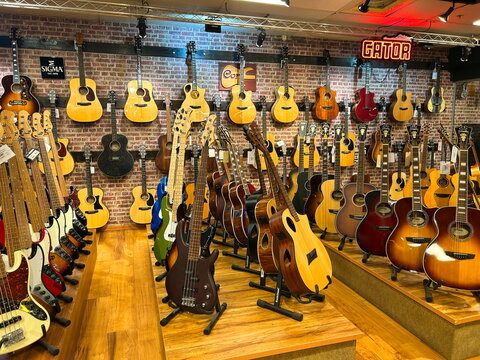 Rishon Le Zion Israel 2 july 2026  Interior of a modern music store with acoustic and electric guitars hanging on the wall.Showroom of a musical instrument shop featuring a wide selection of guitars f