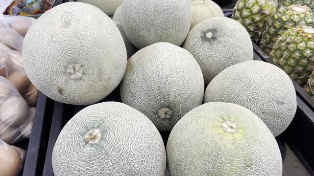 Fresh Ripe Cantaloupe Melons Pile Display in Tropical Fruit Market
