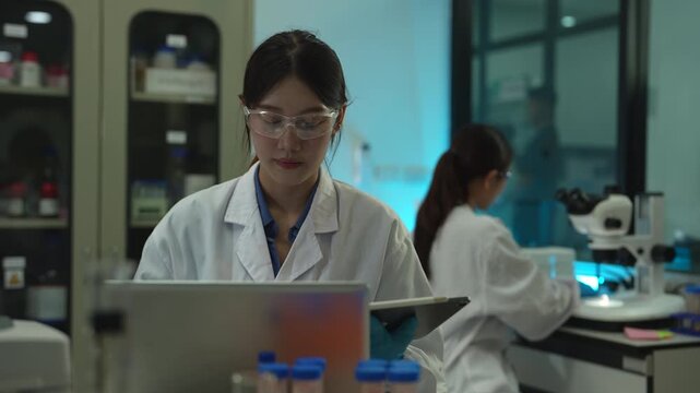 Scientists conduct chemical research and data analysis in a modern laboratory, driving innovation, biotechnology, healthcare, and scientific discovery through teamwork.