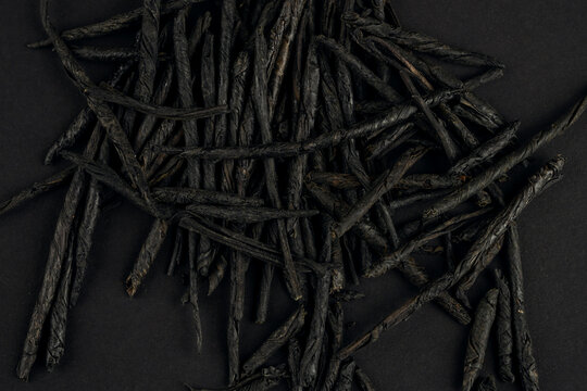 Kuding spear tea leaves arranged on a dark surface for display