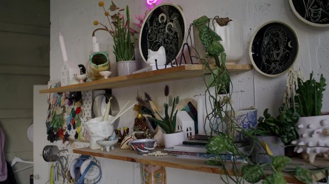 Creative studio shelf with plants and handmade decorations