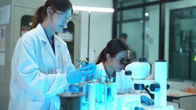 Researcher testing water purity through a microscope, monitoring soil moisture and crop health in a modern laboratory, advancing agricultural science and sustainability.