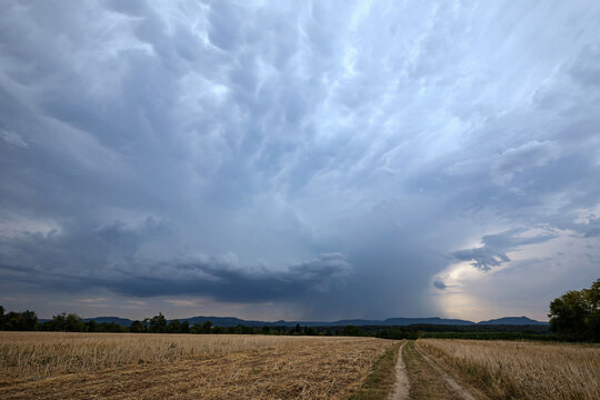 Dramatic Storm Sky Over Harvested Field in Germany