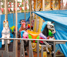 White ponies on an abandoned carousel © Marina