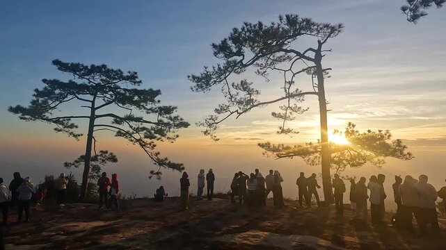 Landscape orange nature of Nok Aen Cliff Phu Kradueng with Silhouett Traveller in the Morning Sunrise at Phu Kradueng National Park Loei Thailand - Peaceful and Calm