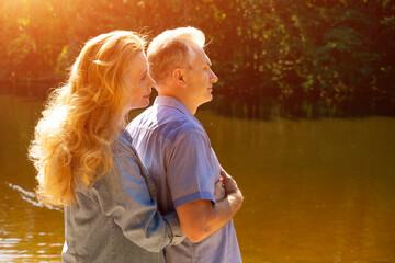 Profile Portrait of a Mature Couple by a Golden Park Pond © Екатерина Переславце
