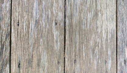 Obraz premium A rustic weathered wood plank background texture. Featuring varying light and dark brown tones with rich, detailed natural grain and a rough, distressed surface. Ideal for design backgrounds.