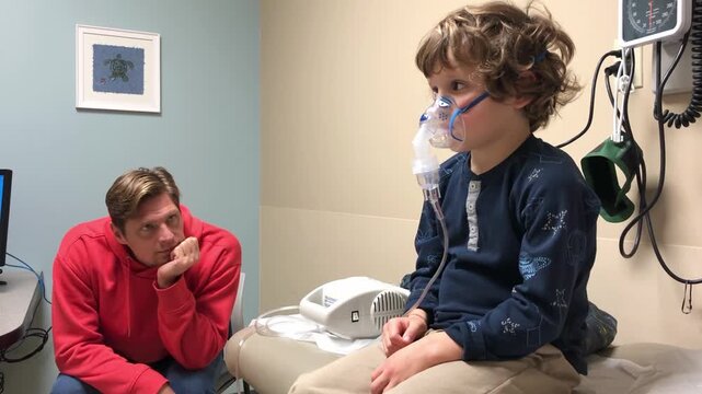 Child wearing a nebulizer mask during a respiratory therapy session while sitting on hospital bed with parent nearby. Healthcare scene illustrating pediatric treatment, family support, asthma care.