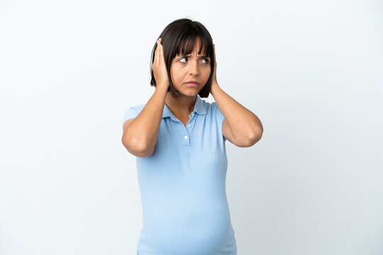 Pregnant woman over isolated white background frustrated and covering ears