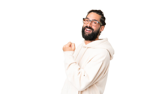 Young man with beard over isolated chroma key background celebrating a victory