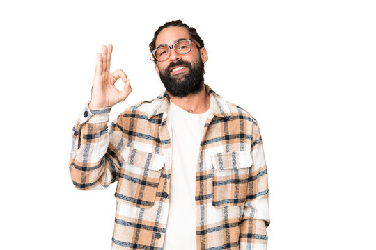 Young man with beard over isolated chroma key background showing ok sign with fingers