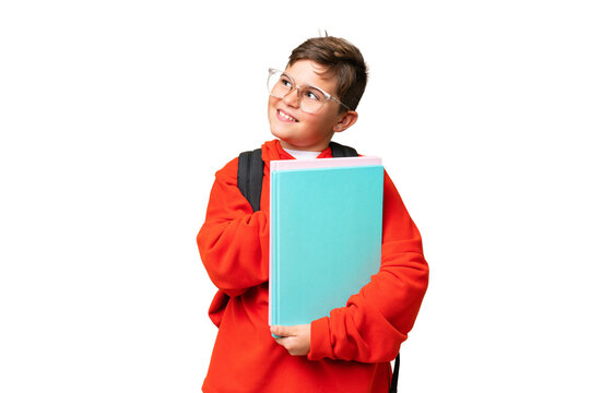 Little caucasian student kid over isolated chroma key background looking up while smiling