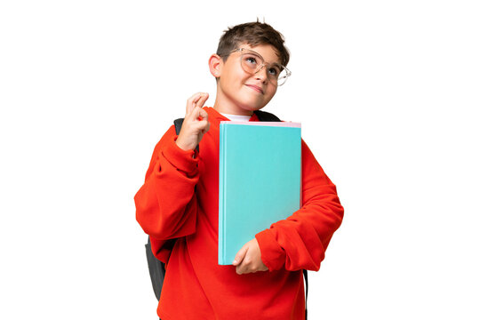 Little caucasian student kid over isolated chroma key background with fingers crossing and wishing the best