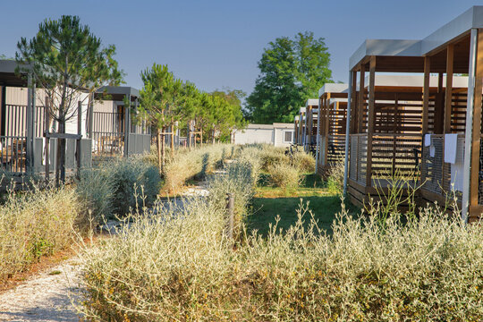 Modern mobile homes with covered porches at resort in Croatia.