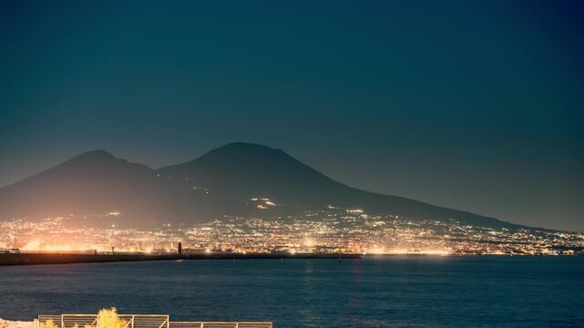 Naples and the coast facing Mount Vesuvius at night, harbor traffic