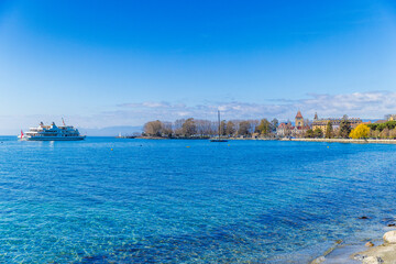 Fototapeta premium Lake Geneva shoreline with sunny Lausanne view, Switzerland