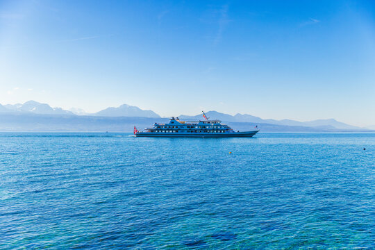Passenger ferry on Lake Geneva with majestic Alps in background