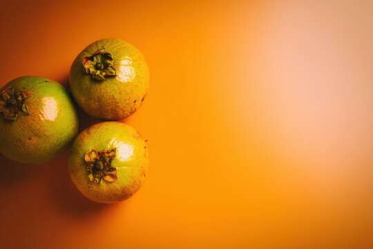 Ultra realistic canistel fruits, 3-4 whole fruits, dense matte yellow skin, top-down flat lay, wide clean composition with space for text
