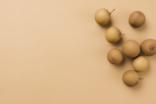 Ultra realistic longan fruits, 6-8 whole fruits, smooth light-brown skin, top-down flat lay, wide clean composition with space for text