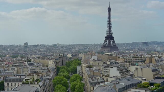 Breathtaking aerial view capturing the magnificent Eiffel Tower standing tall amidst the sprawling cityscape of Paris, with historic buildings and tree lined avenues stretching into the distance
