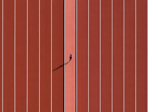 Aerial View of a Track and Field Oval with a Runner in the Middle