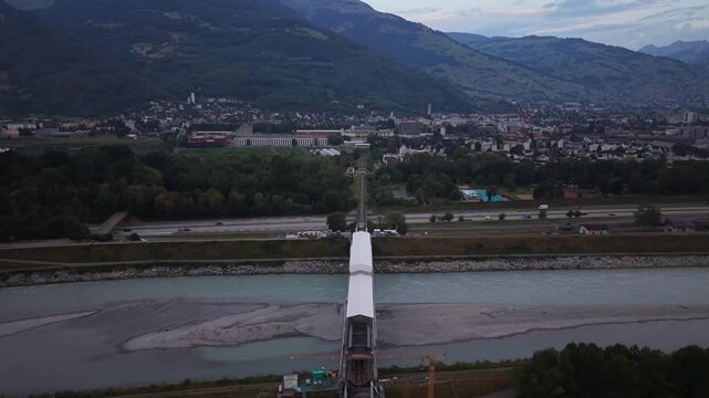 Drone flight along a railway bridge enclosed by a temporary protective roof during renovation, with additional railway construction visible farther toward the city.