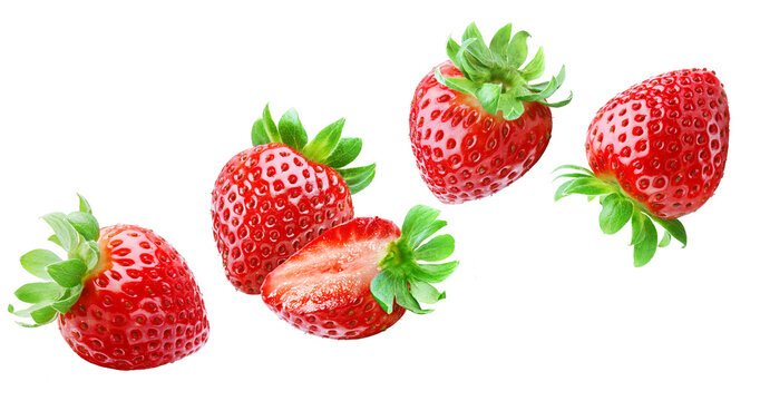 Flying ripe juicy strawberries with leaves isolated on transparent background.