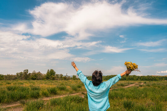 Woman with arms outstretched enjoying nature and freedom