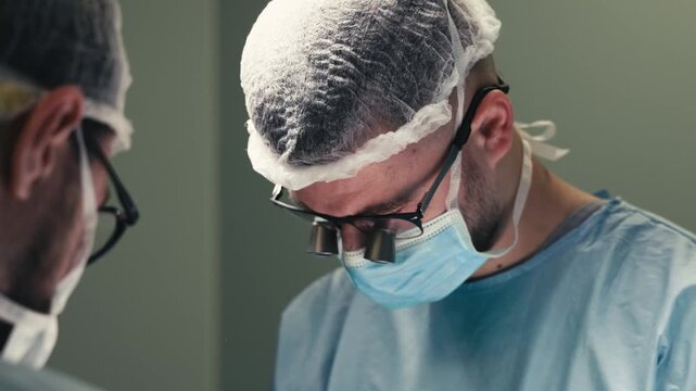 Close-up portrait of surgeons concentrating during a complex medical procedure. Concept professional surgery, teamwork, advanced medical technology and clinical care.