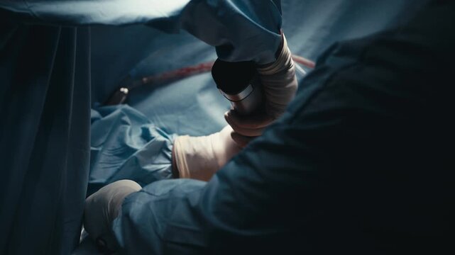 Surgeons&rsquo; gloved hands working with medical instruments during surgery. Concept surgical expertise, precision care and patient safety.