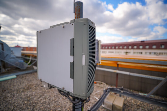 Outdoor telecommunication equipment box mounted on rooftop mast