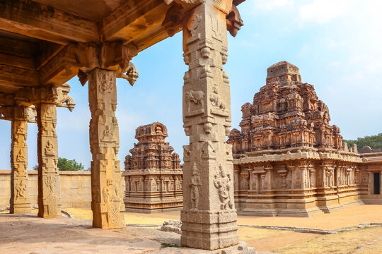 Ancient stone temple ruins and historic carved architecture in Hampi, India. Beautiful landscape with archaeological site, cultural heritage landmark and popular international tourist destination.