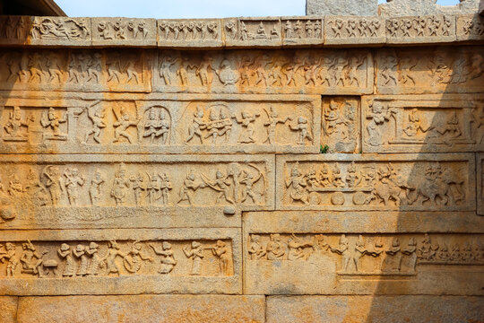 Ancient stone temple ruins and historic carved architecture in Hampi, India. Beautiful landscape with archaeological site, cultural heritage landmark and popular international tourist destination.