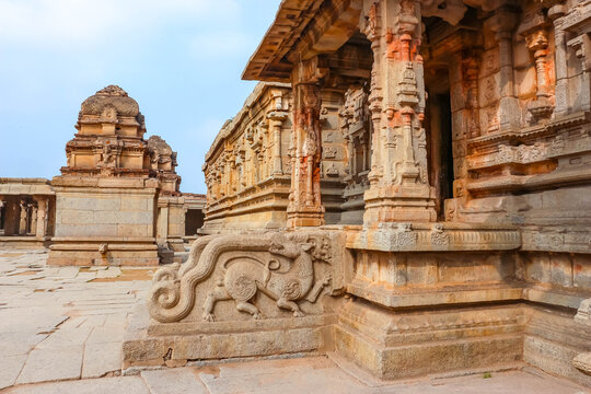 Ancient stone temple ruins and historic carved architecture in Hampi, India. Beautiful landscape with archaeological site, cultural heritage landmark and popular international tourist destination.