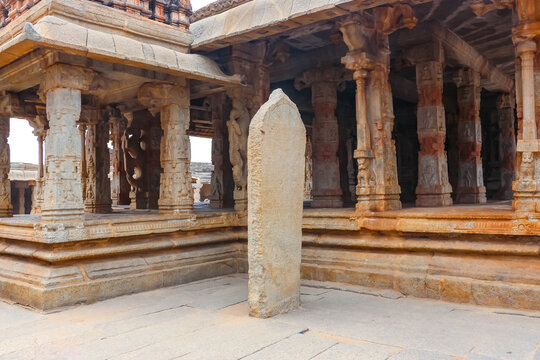 Ancient stone temple ruins and historic carved architecture in Hampi, India. Beautiful landscape with archaeological site, cultural heritage landmark and popular international tourist destination.