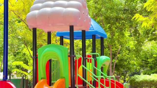 THAILAND - AUGUST 22, 2026: Vibrant and colorful children playground equipment featuring slides, climbing frames, and outdoor recreational structures in a sunny public park.